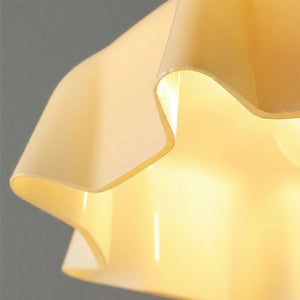 Close-up of a yellow lampshade against a dark background