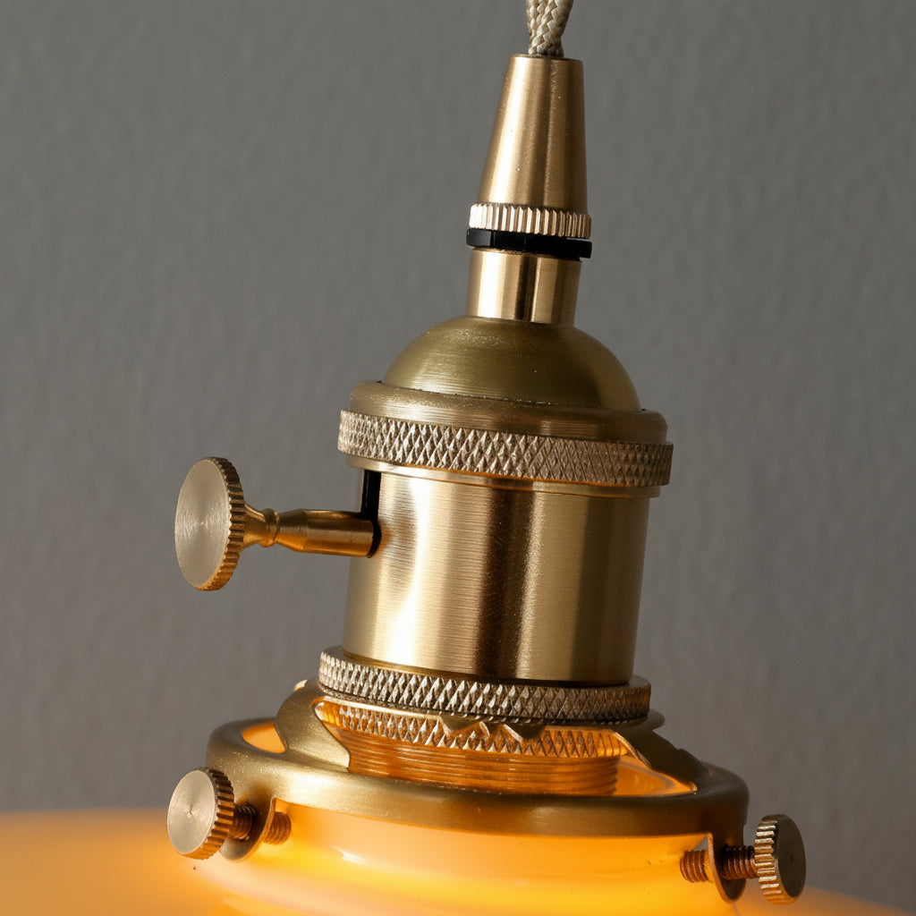 Close-up of a brass lamp with a warm glow against a gray background