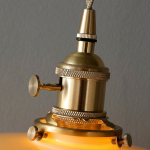 Close-up of a brass lamp with a warm glow against a gray background