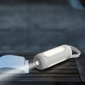 Two portable lights on a wooden surface with a dark background