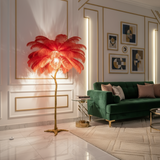 Modern living room with a decorative feathered floor lamp and green sofa.