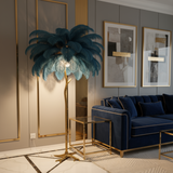 Modern living room with a blue sofa, decorative plant, and framed art on a gray wall.