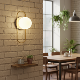 Wall-mounted light fixture on a brick wall with a blurred dining area in the background