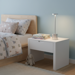 Children's bedroom with a bed, nightstand, and lamp.
