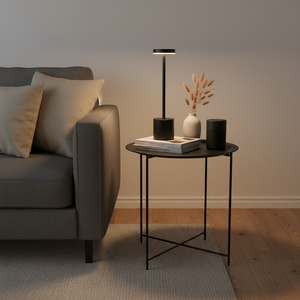 Modern living room with a gray sofa, side table, and decorative items.