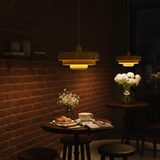 Dimly lit restaurant setting with brick wall, table with food, and hanging lights.