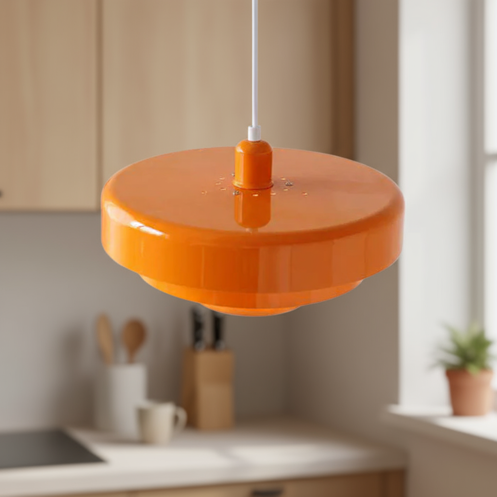 Orange pendant light in a kitchen setting