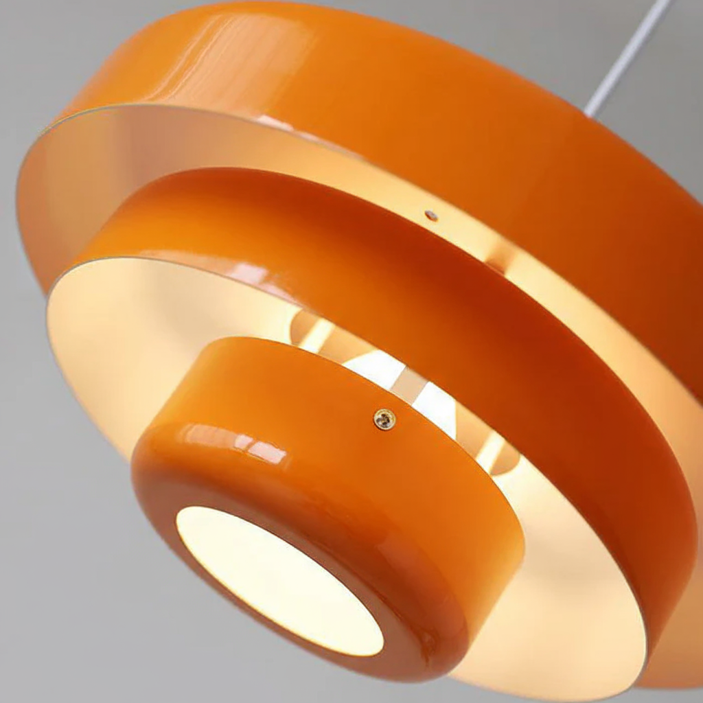 Orange pendant light fixture on a gray background