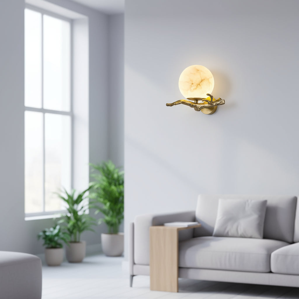 Modern wall lamp in a living room with a gray sofa and plants.