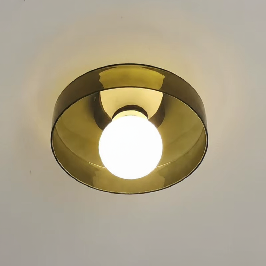 Gold circular light fixture on a white ceiling