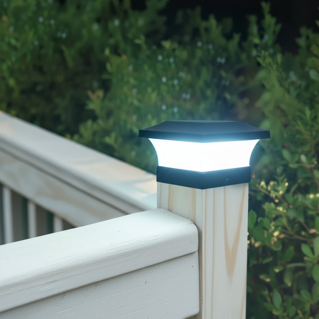 Solar-powered outdoor light fixture on a wooden post with greenery in the background