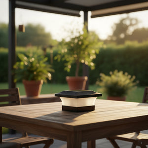 Solar lamp on a wooden table with a garden background