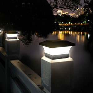 Hexagonal solar lights on a dock at night with city skyline in the background