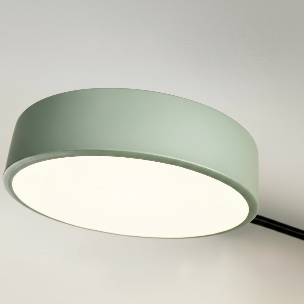 Ceiling light fixture with a greenish-gray shade on a plain background